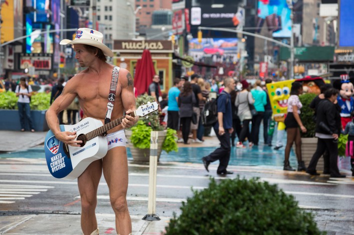 Naked Cowboy playing guitar on Times Square, New York City