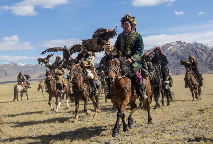 Mongolian eagle hunters riding to the festival iStock_000022566248_Large EDITORIAL ONLY Josef Friedhuber