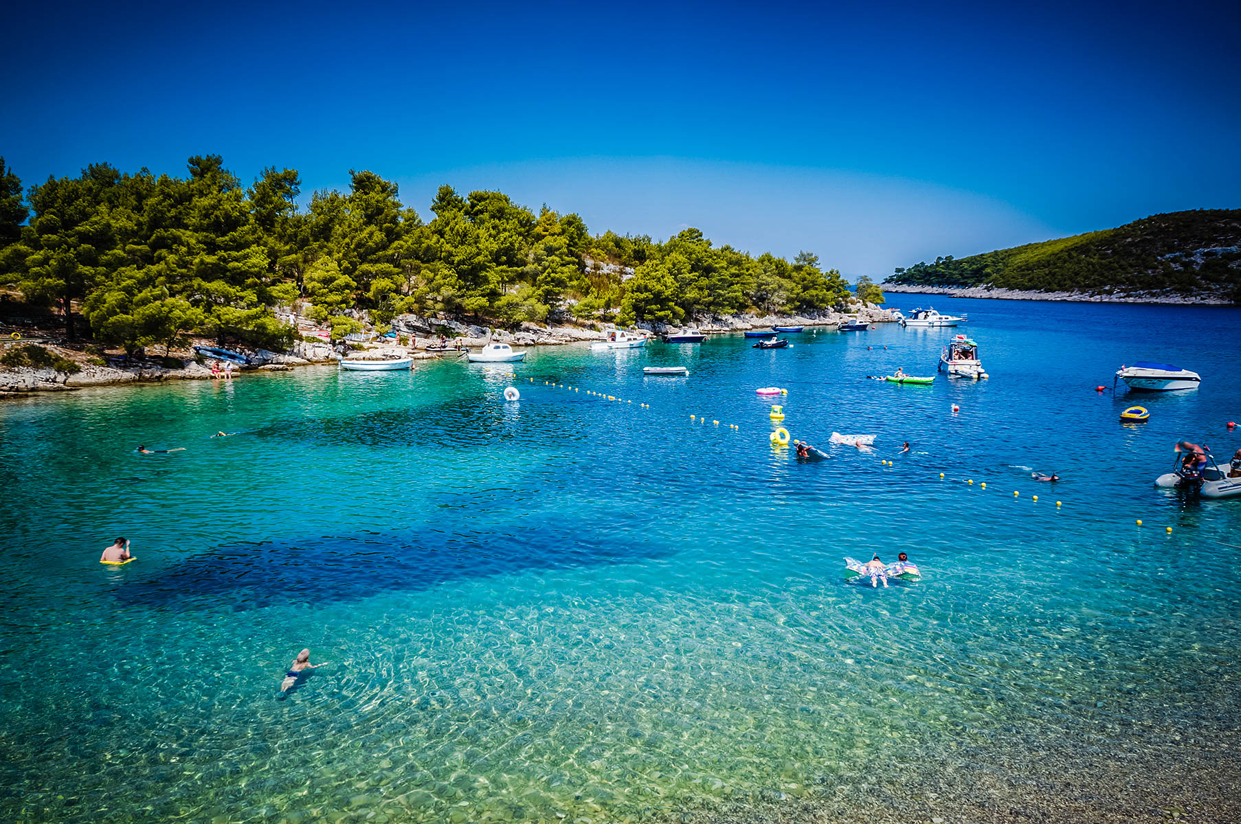 people playing swimming at sea bay summer resort hvar croat istock_24476767_medium 2